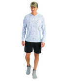 Man wearing a light blue camouflage hoodie with 'Huk' logo and a green cap on a white background