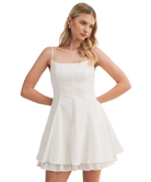Woman wearing a white dress on a white background