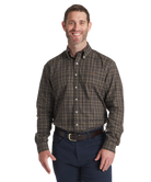 Man wearing a Southern Marsh plaid shirt and dark pants on a white background
