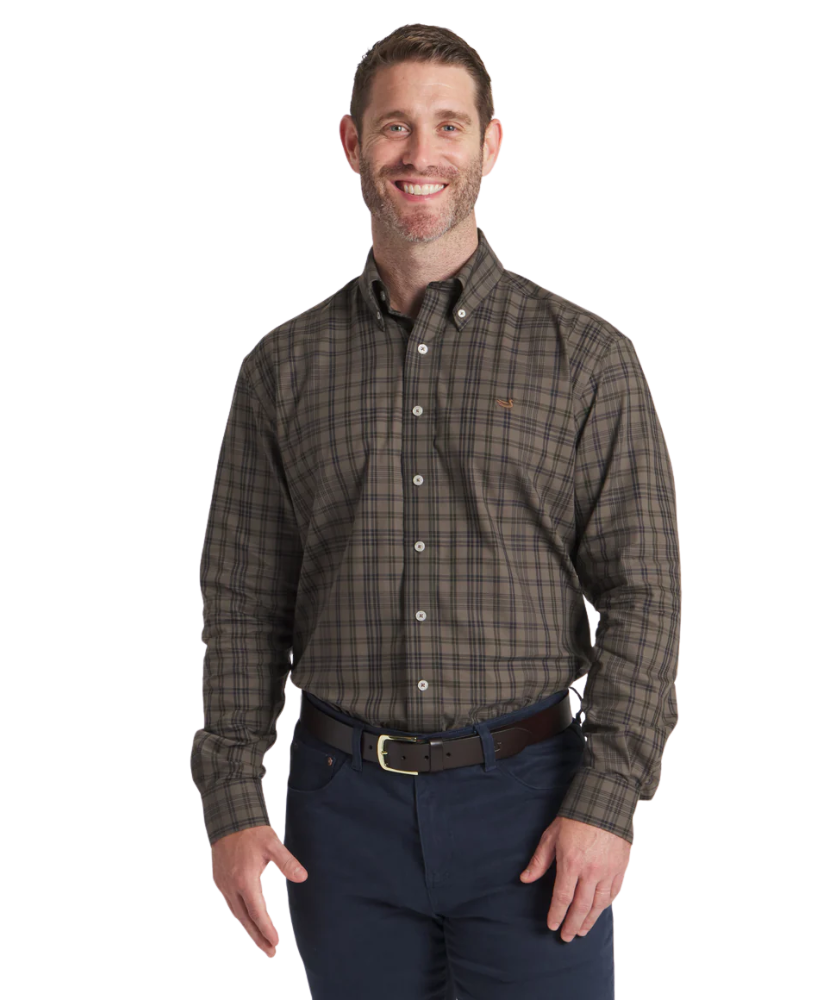 Man wearing a Southern Marsh plaid shirt and dark pants on a white background