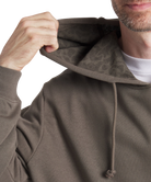 Person wearing a brown hoodie with a white background