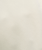 Close-up of a textured light gray fabric pants