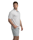 Man wearing a white polo shirt with red Alabama state outline pattern and 'SSCO' logo on a white background and light shorts on a white background