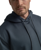 Man wearing a dark blue hoodie on a white background