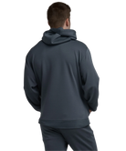 Person wearing a dark blue hoodie and pants on a white background