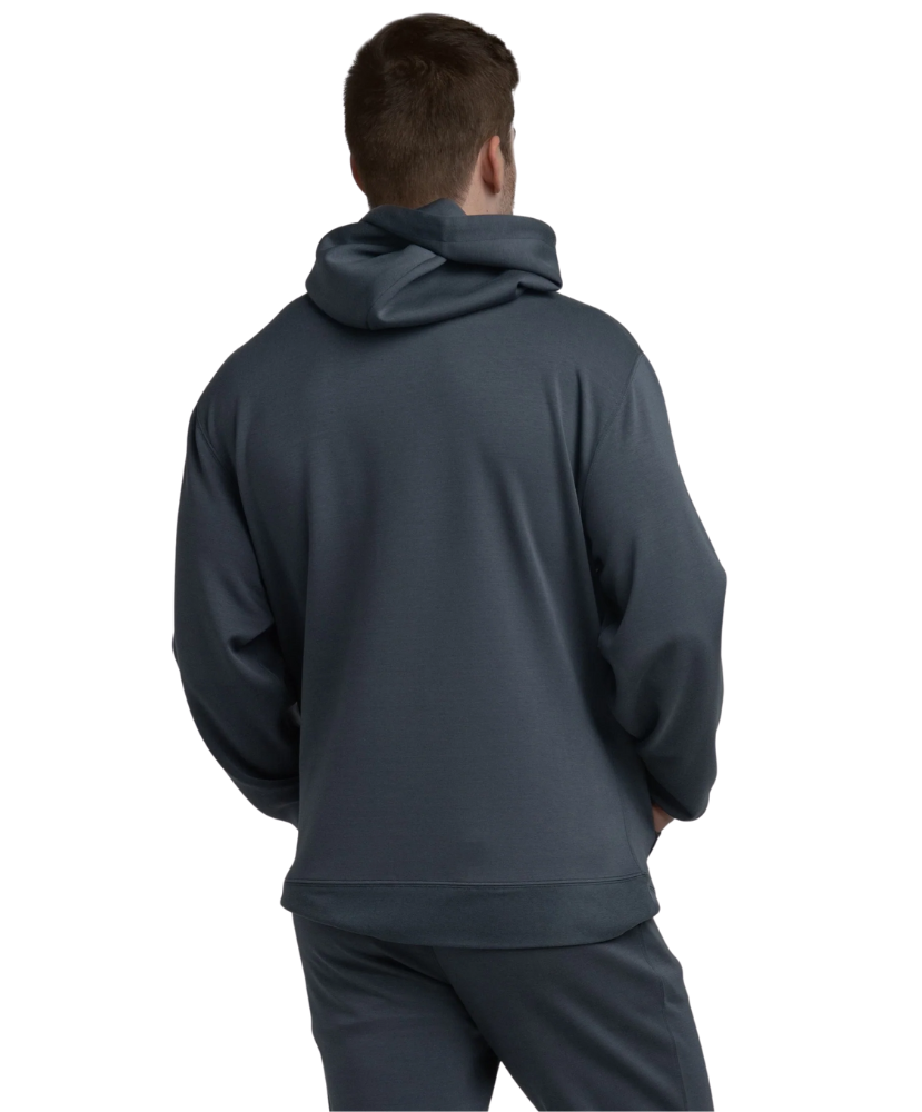 Person wearing a dark blue hoodie and pants on a white background