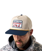 Man wearing a beige and navy cap with 'Burlebo Outdoors' logo on a white background