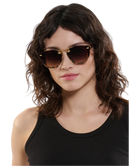 Woman wearing Krewe sunglasses with a neutral background