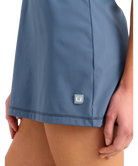 Blue dress with a HUK logo on a white background