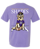 A purple short-sleeve t-shirt with a large graphic on the back. The graphic features the text 'SUNGLASSES & GUNGLASSES APPAREL SHADES' in white and yellow, with a cartoon golden retriever wearing a purple and gold football jersey and a matching cap, sitting on a football.