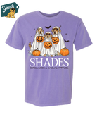 Purple t-shirt with Halloween-themed design of dogs in costumes and pumpkins, brand 'Shades' visible.