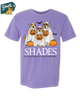 Purple t-shirt with Halloween-themed design of dogs in costumes and pumpkins, brand 'Shades' visible.