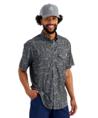 Man wearing a LURES patterned shirt and cap on a white background