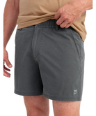 Person wearing gray HUK shorts on a white background