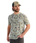 Man wearing a camouflage t-shirt and cap on a white background