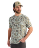 Man wearing a camouflage t-shirt and cap on a white background