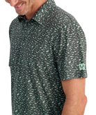 Man wearing a FISH patterned polo shirt with a visible brand logo on a white background