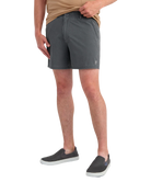 Person wearing gray shorts on a white background