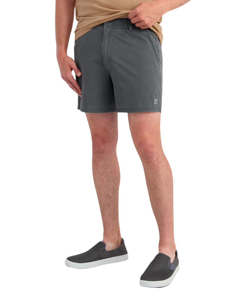 Person wearing gray shorts on a white background