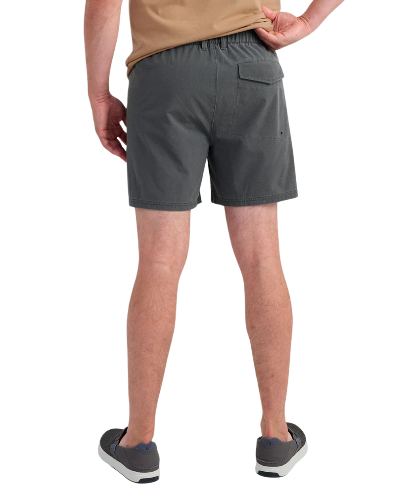 Person wearing gray HUK shorts on a white background