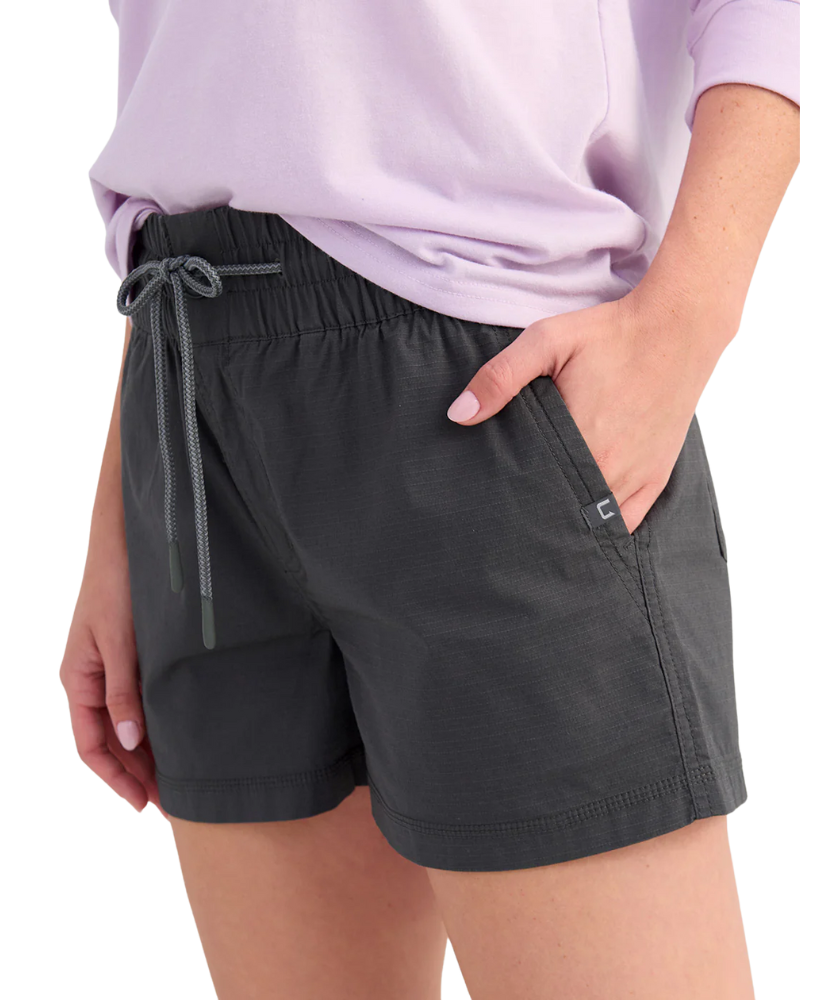 Woman wearing black shorts with a drawstring and front pocket on a white background