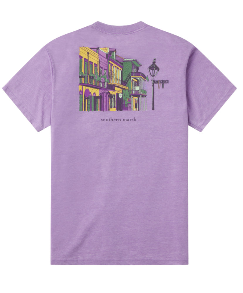 Purple Mardi Gras t-shirt with a colorful graphic of a New Orleans street scene on the back, on a white background.