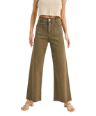 Person wearing high-waisted brown pants on a white background