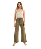Woman wearing a beige top and olive green wide-leg pants on a white background