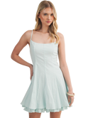 Woman wearing a light blue dress on a white background