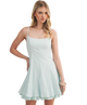 Woman wearing a light blue dress on a white background