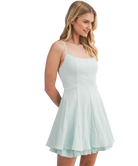 Woman wearing a light blue dress on a white background
