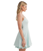 Woman wearing a light blue dress on a white background