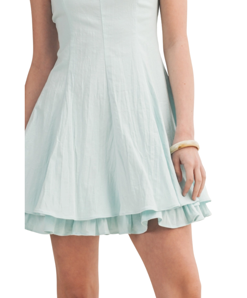 Light blue dress with ruffled hem on a white background
