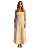 Woman wearing a strapless dress with a white background