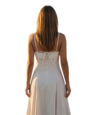 Woman wearing a white dress with thin straps on a white background