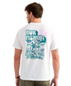 Man wearing a white Huk Fishing t-shirt with a graphic of a dog on the back.