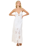 Woman wearing a white dress with cut-out design on a white background