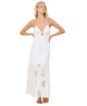 Woman wearing a white dress with cut-out design on a white background
