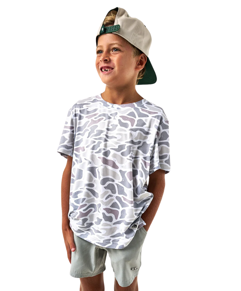 Child wearing a white camouflage t-shirt and light gray shorts on a white background