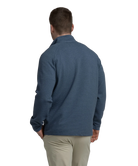 Man wearing a textured blue quater-zip on a white background