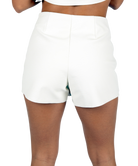 Woman wearing a white skort on a white background