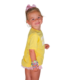 Young girl wearing a yellow outfit with a white logo on a white background
