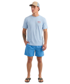 Man wearing a light blue t-shirt and shorts with a cap on a white background