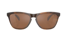 A pair of oversized square sunglasses with a dark brown tortoiseshell frame and warm brown lenses, shown against a plain white background.