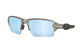 Oakley sunglasses with a translucent smoky gray frame and light blue mirrored lenses, shown from a three-quarters angle on a white background.