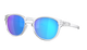 Oakley sunglasses with a translucent clear frame and vibrant mirrored blue and purple lenses, shown on a solid white background.