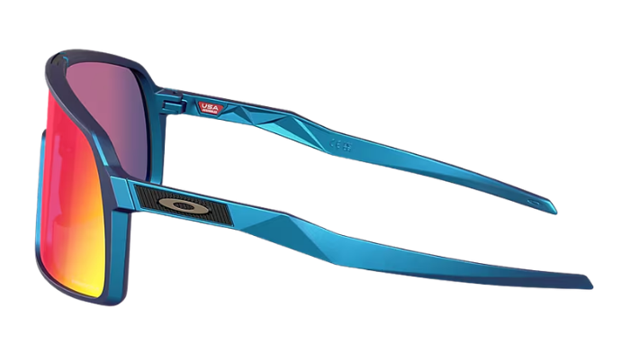 Oakley wraparound sunglasses with a metallic blue frame and vibrant red-to-yellow mirrored lenses, shown on a plain white background.