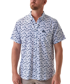 Man wearing a white short-sleeve button down shirt with a blue coastal pattern on a white background
