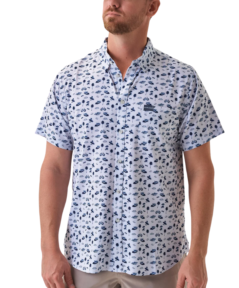 Man wearing a white short-sleeve button down shirt with a blue coastal pattern on a white background
