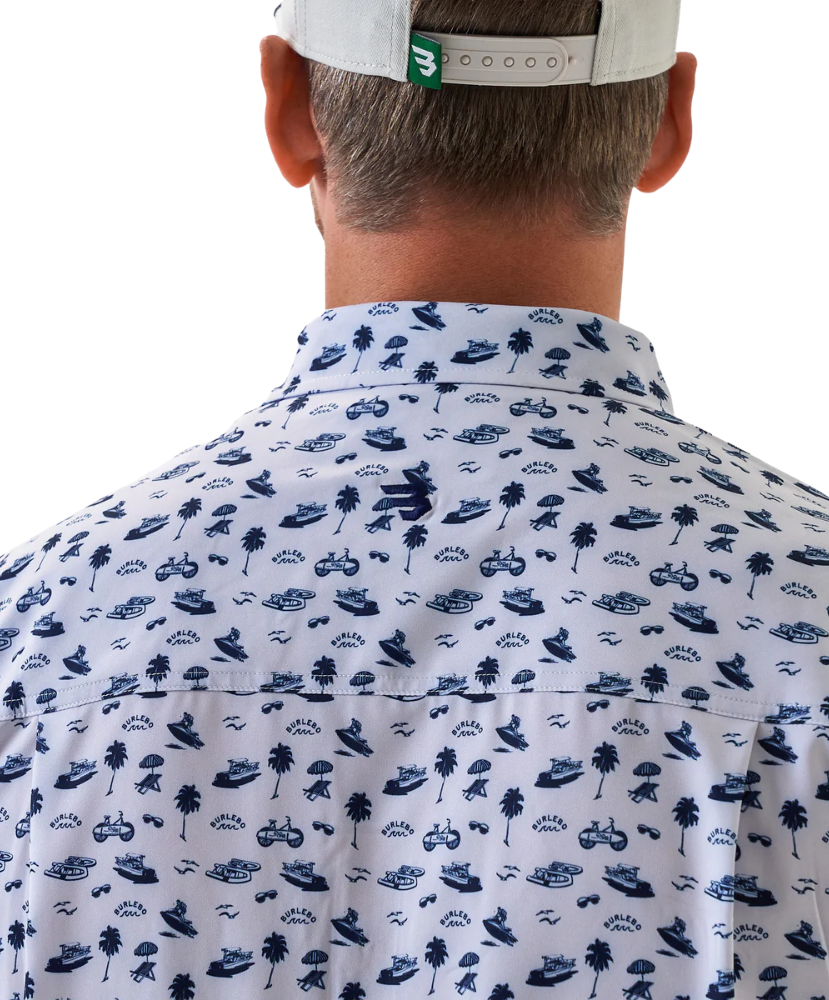Man wearing a white short-sleeve button down shirt with a blue coastal pattern on a white background
